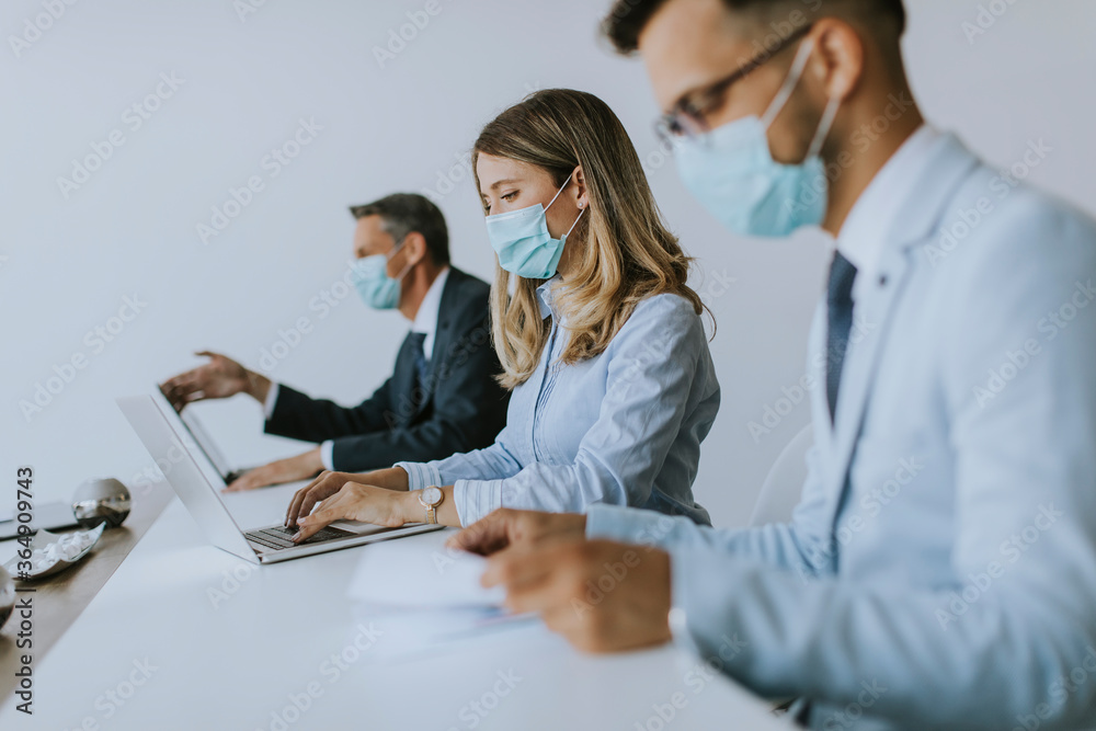 Fototapeta premium Group of business people have a meeting and working in office and wear masks as protection from corona virus