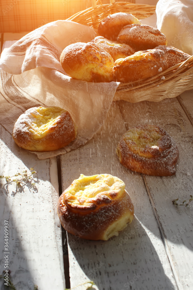 Fresh cheesecakes in a basket on a wooden table in the sun. Homemade cake. Confectionery. Fresh cheesecakes in a basket on a wooden table in the sun. Homemade cake. Confectionery.
