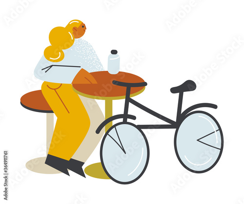 Girl sitting and having drink with her bicycle near on open veranda