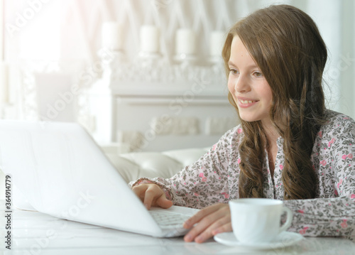 Portrait of cute girl using laptop at home