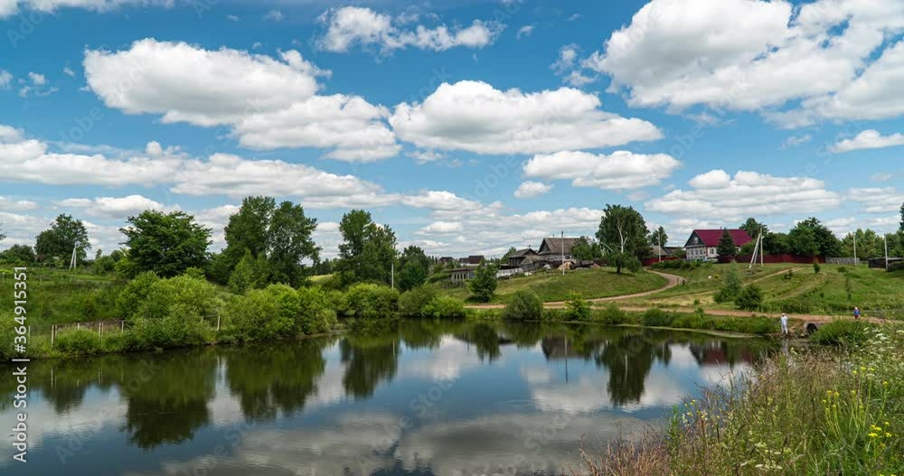 Village landscape with a small lake, time lapse of clouds reflected in the water, beautiful summer landscape Village landscape with a small lake, time lapse of clouds reflected in the water, beautiful summer landscape