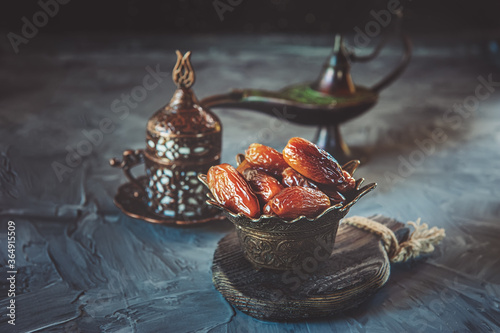 old vase with dates and a Cup of tea. Beautiful still life for a Muslim holiday