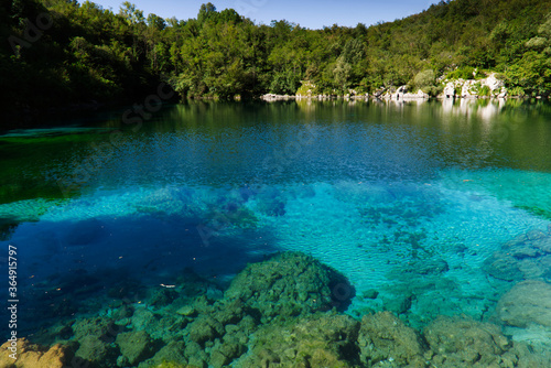 The emerald waters of Lake Cornino in the Cornino regional nature reserve, Italy