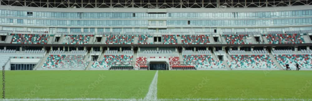 WIDE workers checking field and fixing grass before the game on a stadium. Shot on RED cinema camera with Anamorphic lens WIDE workers checking field and fixing grass before the game on a stadium. Shot on RED cinema camera with Anamorphic lens