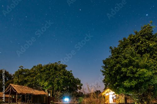 Night view of wooden shacks under the sky