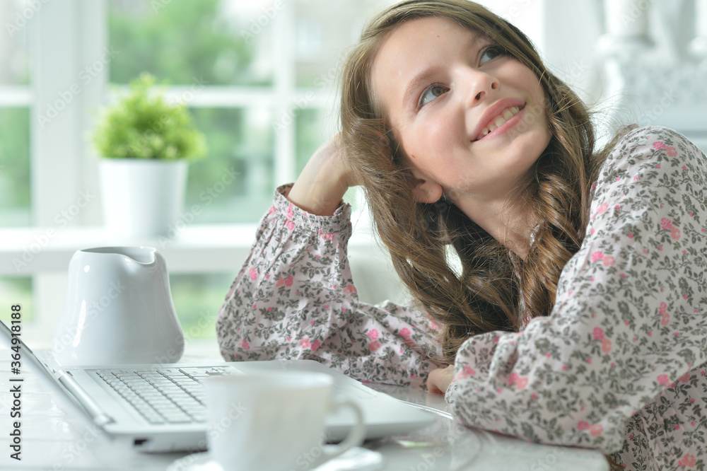 Portrait of cute girl using laptop at home Portrait of cute girl using laptop at home