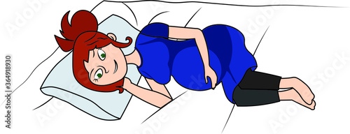 Happy pregnant woman laying on a bed thinking about her baby
