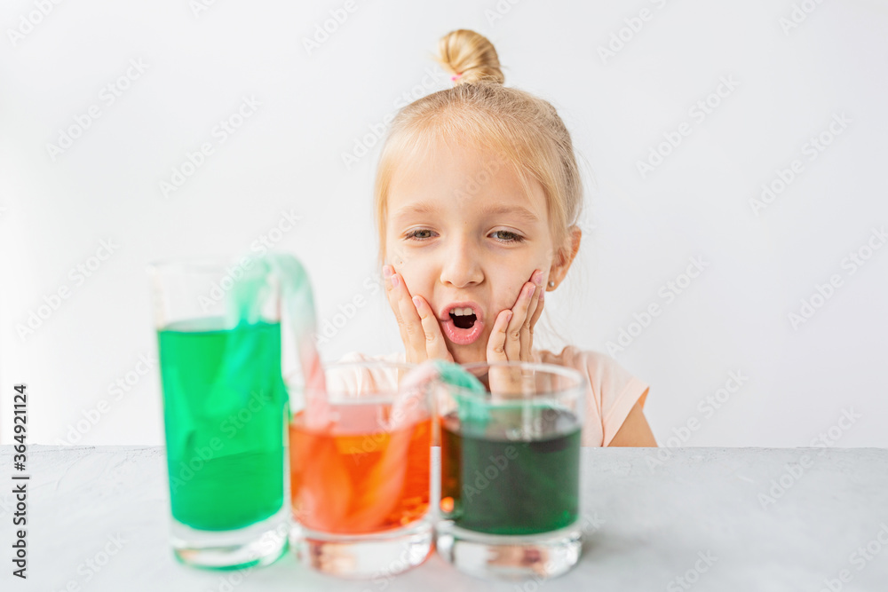 cute little girl six years old doing laboratory experiment with colorful water in classroom. Education science concept. Selective focus. Distance learning during covid-19 coronavirus quarantine. cute little girl six years old doing laboratory experiment with colorful water in classroom. Education science concept. Selective focus. Distance learning during covid-19 coronavirus quarantine.