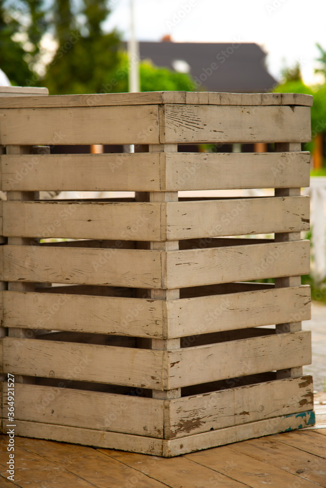 A box made of boards with peeling paint. A box made of boards with peeling paint.