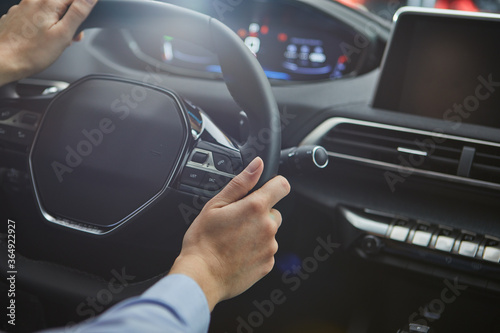 female hands on the steering wheel of a car
