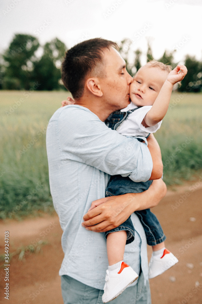 Obraz premium A happy family walks with a child in nature