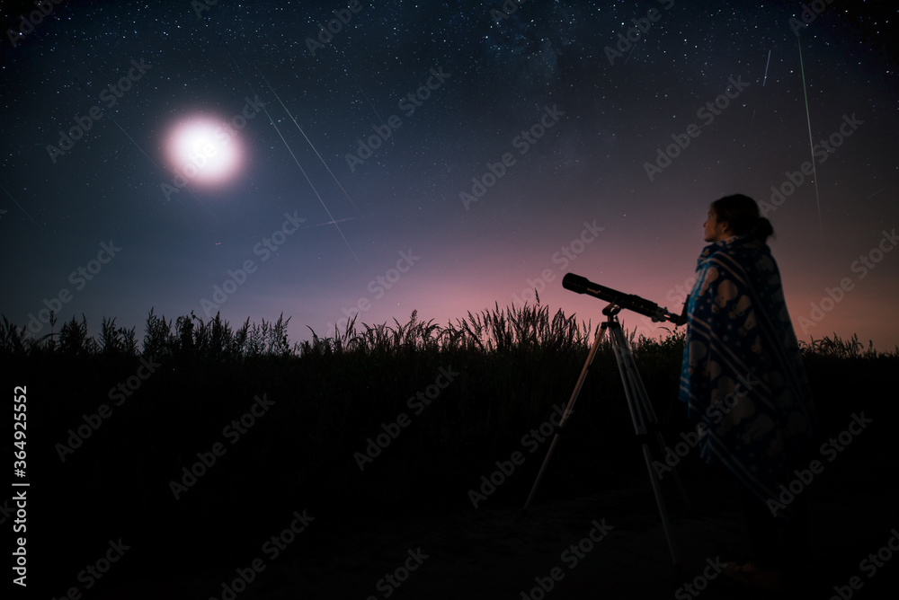 silhouette of a woman with a telescope