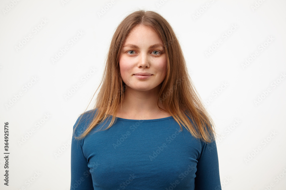 Portrait of attractive young white-headed female with natural makeup smiling gently while looking positively at camera, isolated over white background Portrait of attractive young white-headed female with natural makeup smiling gently while looking positively at camera, isolated over white background