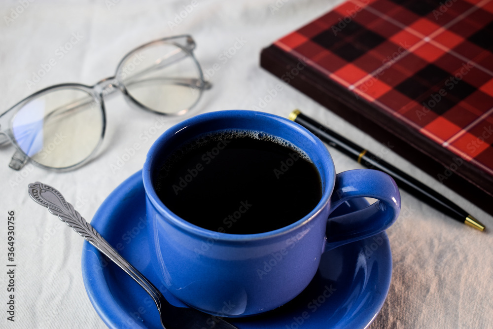 Cup Of Coffee with pen,book and glasses on white background. relax with coffee concept Cup Of Coffee with pen,book and glasses on white background. relax with coffee concept