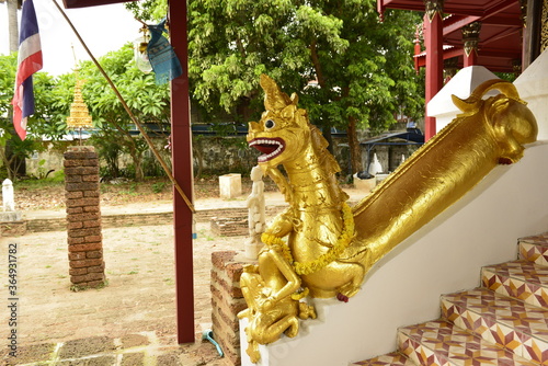 Ancient golden Naga on staircase of Wat SriChum in Lampang province, Thailand. photo