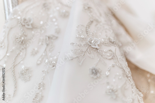 wedding dress close up. white pearls and patterns
