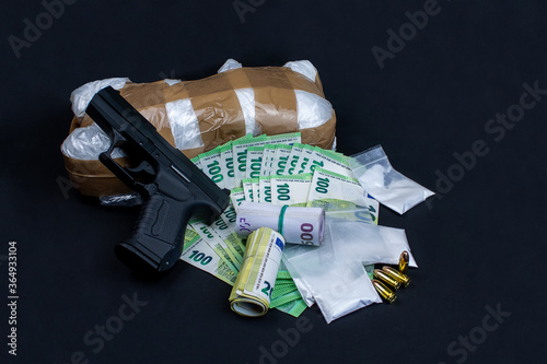 Gun, euro notes and drugs. The money open and rolled. The drugs packed in bags. Individual 9mm cartridges are included.