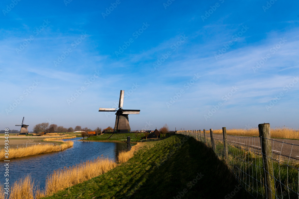 Typical Dutch Windmills Country Side in Bright and Vivid Color with Blue Sky Background Wallpaper and River Typical Dutch Windmills Country Side in Bright and Vivid Color with Blue Sky Background Wallpaper and River