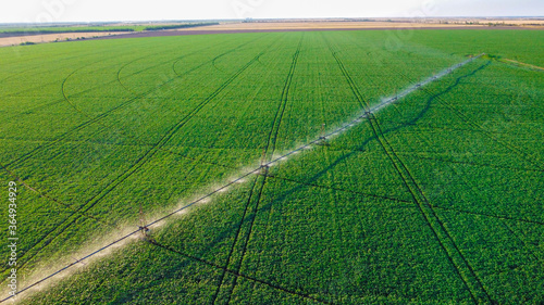 Vászonkép farming irrigation sprinklers system on cultivated agricultural landscape field
