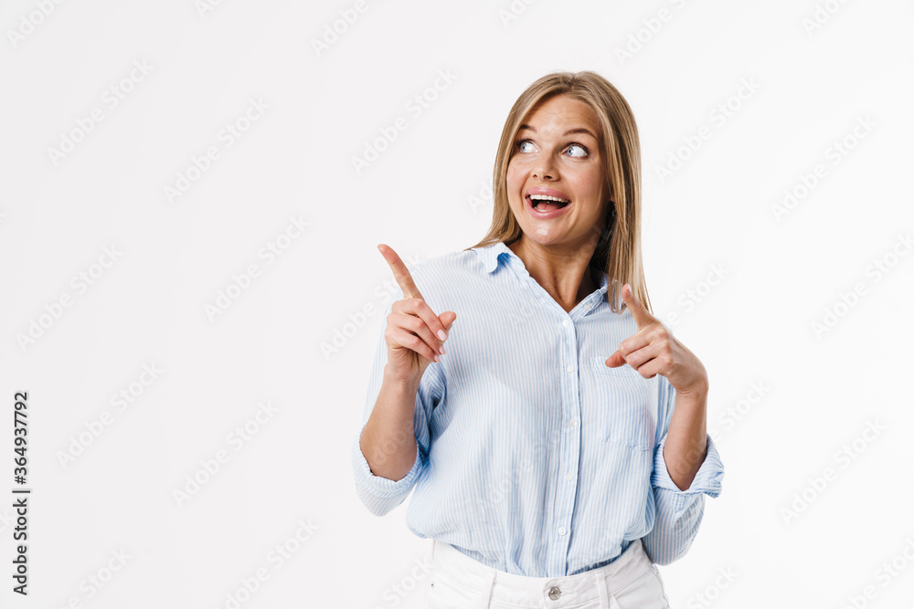Image of surprised blonde woman pointing fingers aside and smiling Image of surprised blonde woman pointing fingers aside and smiling