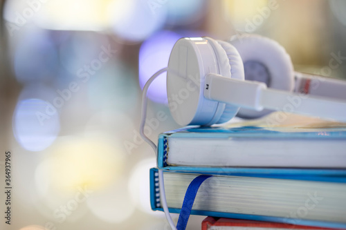 Headphones with books, educational concept.