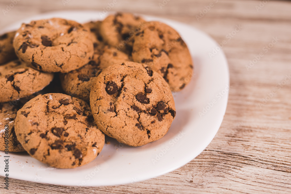 some chocolate cookies on a white plate some chocolate cookies on a white plate