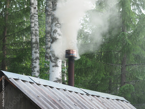 thick smoke comes from the chimney. forest