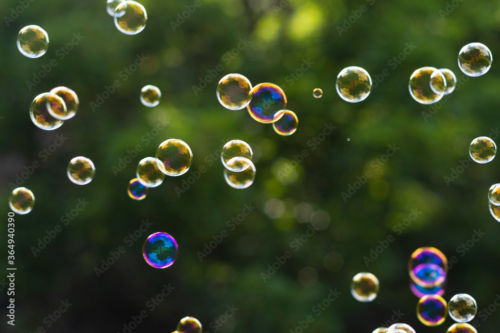 Abstract background with soap bubbles on green summer background.