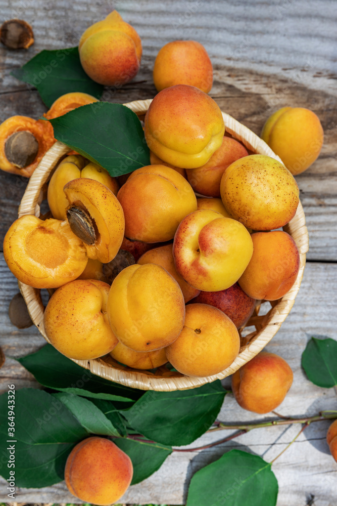 Apricots in a basket on wooden boards, top view down. Fresh fruit concept Apricots in a basket on wooden boards, top view down. Fresh fruit concept