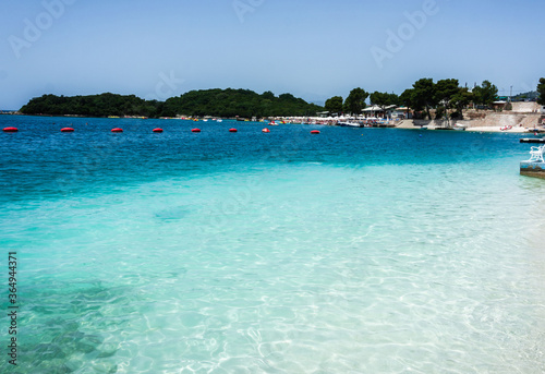 Fototapeta Naklejka Na Ścianę i Meble -  The beautiful beach of Ksamil in a sunny day with clear turquoise water at Sarande, Albania.
