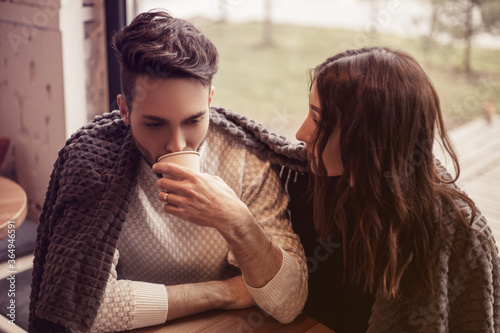The young man had serious problems at work, the girl reassures him. The guy decided to drink coffee and relax in a cozy cafe near the promenade. Trust, relationships, caring, excitement.