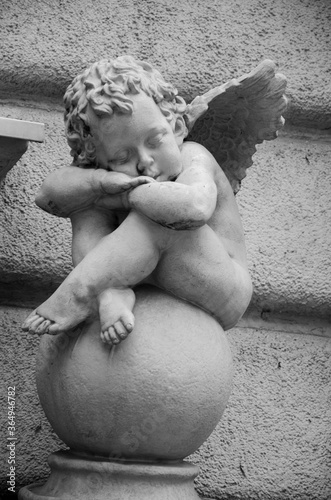 Black and white statue of a white angel. Baby angel on valentines day
