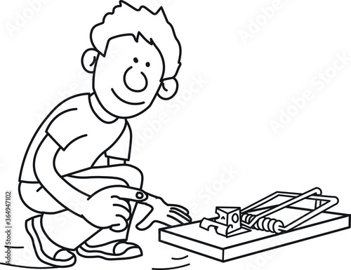 Young boy setting up a mouse trap with a piece of cheese inside watching looking carefully
