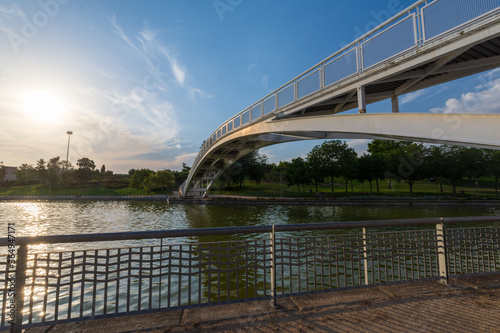 View of bridge over canal  with summer sunset  in a park in Madrid  Spain  horizontal