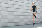 Active lifestyle. Guy athlete in sportswear runs with jumps
