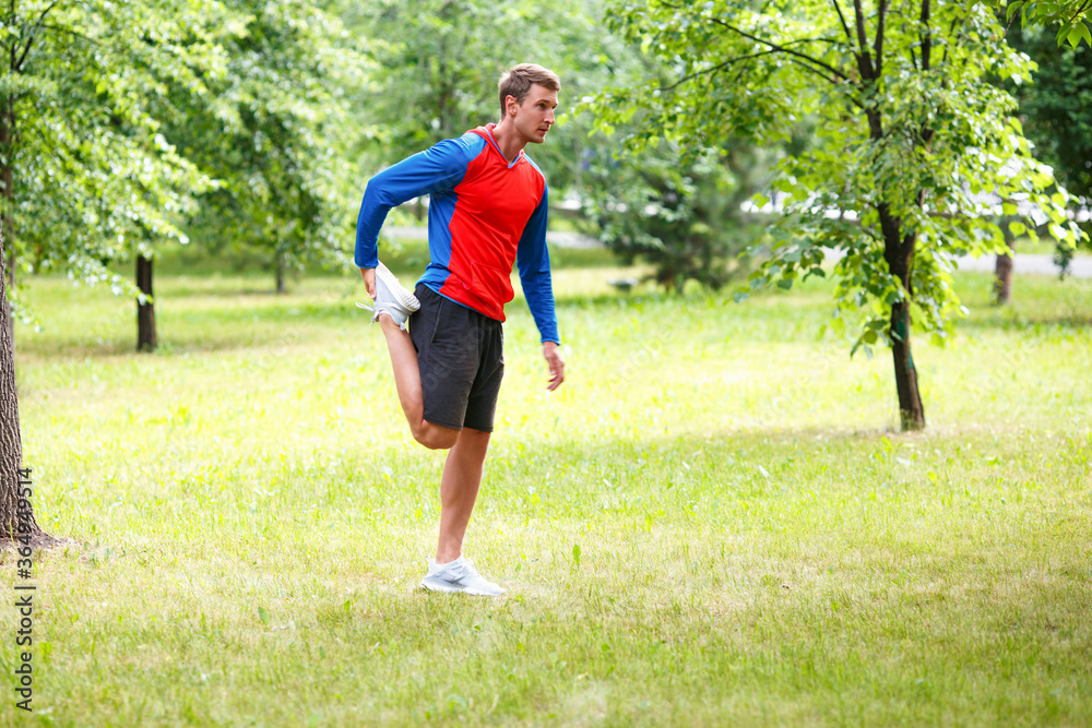 Sport and healthy lifestyle concept - male jogger stretcing muscles. Sport and healthy lifestyle concept - male jogger stretcing muscles.