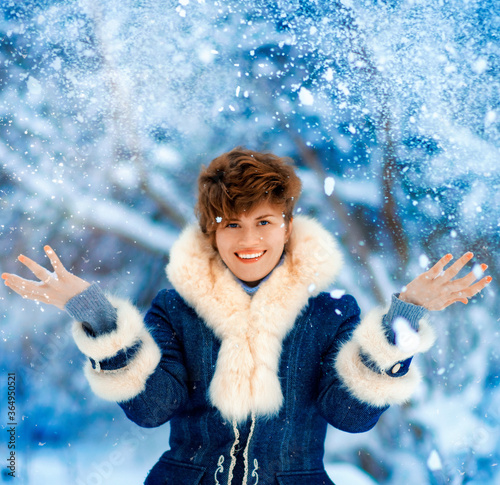 Portrait of joyful Winter Woman with short haircut in Luxury Fur Coat. Beauty Fashion Model Girl in Blue Fox Fur Coat. Beautiful Luxury Winter Lady. Snow and white fur