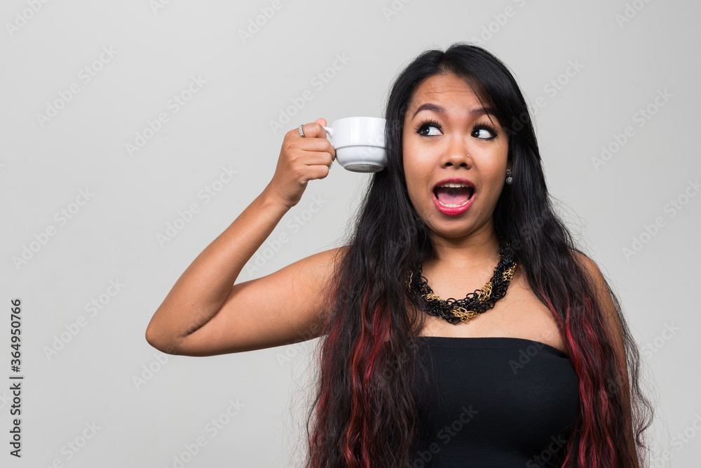 Portrait of young Asian woman against white background Portrait of young Asian woman against white background