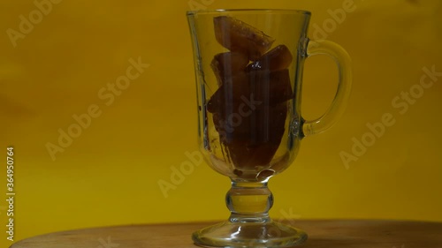 Cooking a summer drink ice coffee on a yellow background