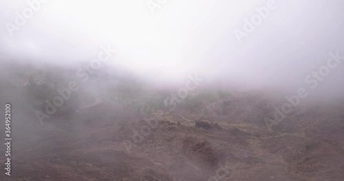 Moving through Clouds in Rocky barren Mountain Valley  in Europe on Vulanic Island  photo