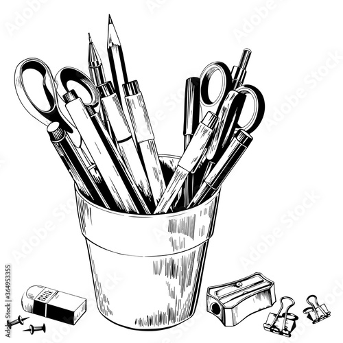 Pencils and pens in a holder isolated on a white background.