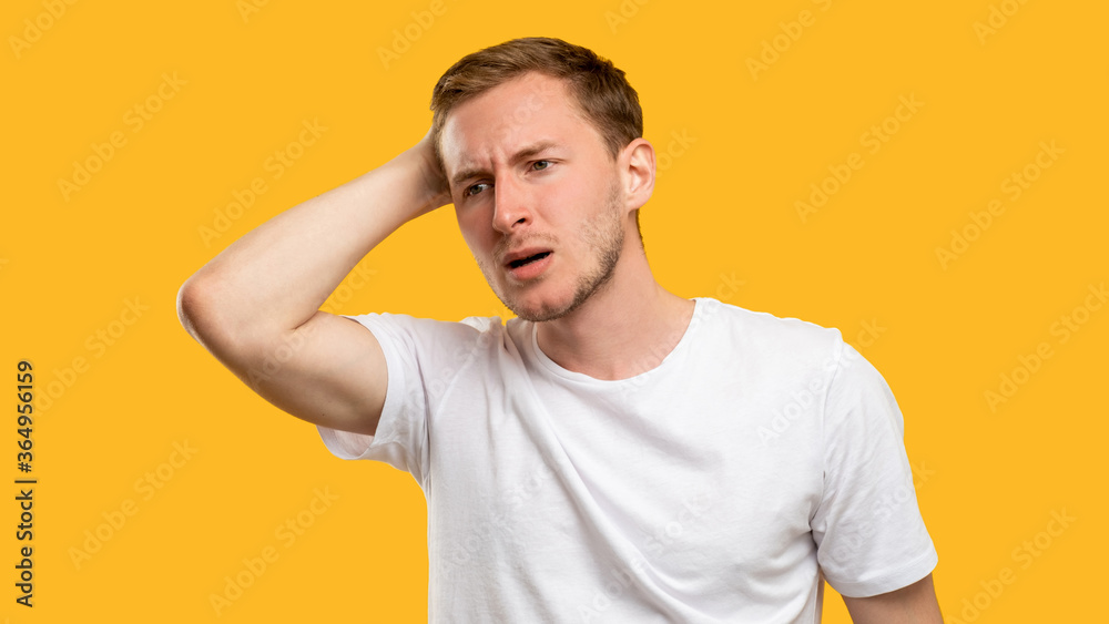 Troubled man portrait. Mistake regret. Concerned guy touching head isolated on orange background. Troubled man portrait. Mistake regret. Concerned guy touching head isolated on orange background.