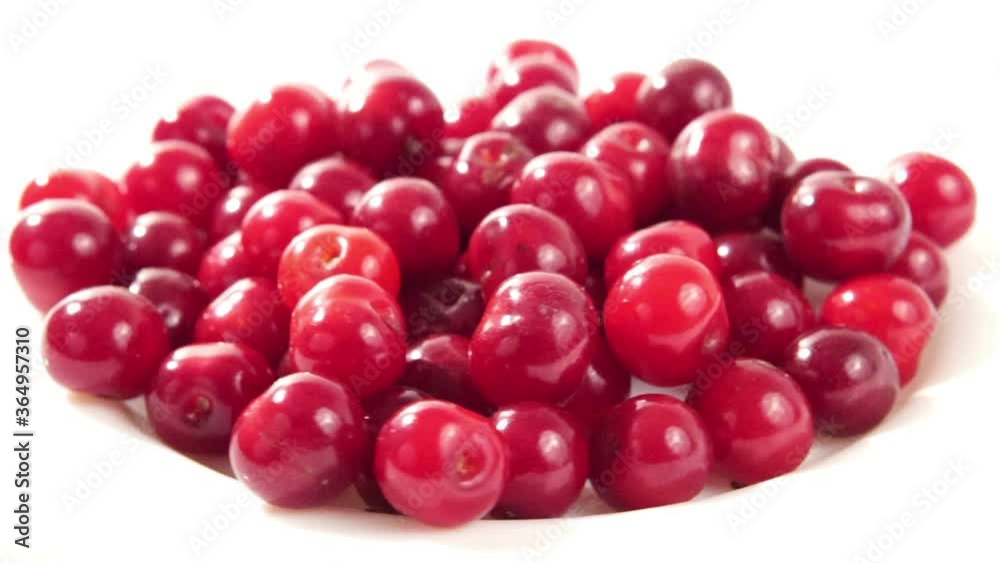 Ripe tasty red cherries are moving on a white plate. Ripe tasty red cherries are moving on a white plate.