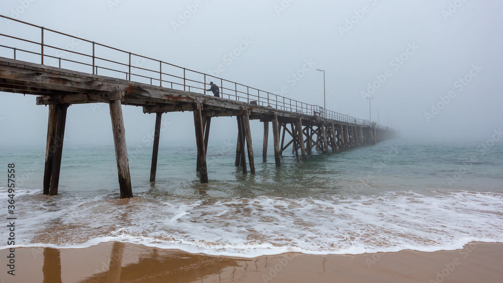 The port noarlunga jetty with a heavy morning fog in port noarlunga south australia on july 14 2020 The port noarlunga jetty with a heavy morning fog in port noarlunga south australia on july 14 2020