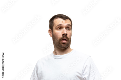 Lost. Young caucasian man with funny, unusual popular emotions and gestures isolated on white studio background. Human emotions, facial expression, sales, ad concept. Trendy look inspired by memes.