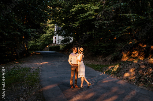 Smiling couple stand among street in embrance photo