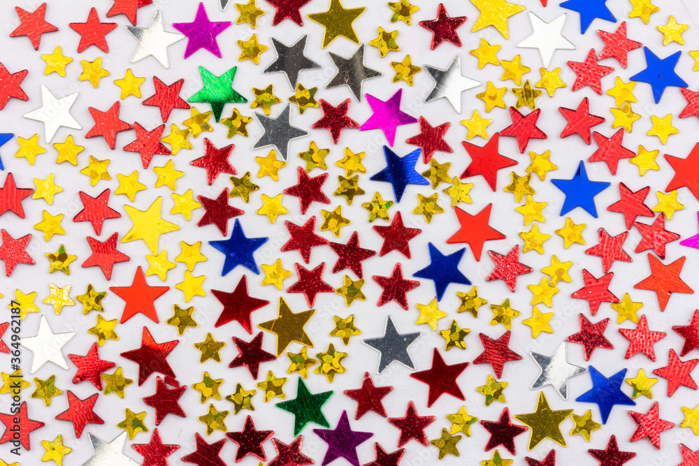 festive background with a pattern of multicolored stars festive background with a pattern of multicolored stars