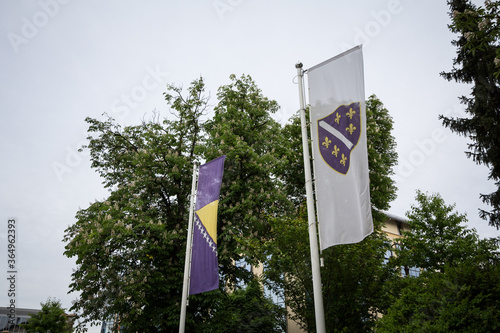 official flag of Bosnia and Herzegovina and its oldest one, usually used by Bosniak people from the Federation waving in the city of Sarajevo, the capital city of Bosnia photo