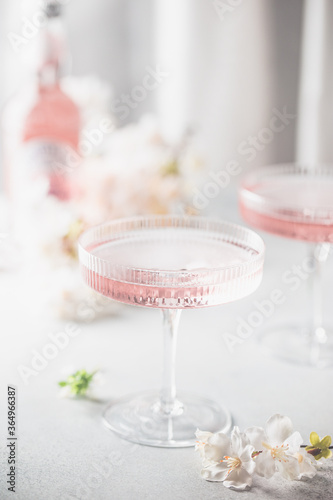 Homemade pink vodka cosmopolitan cocktail drink in crystal glasses