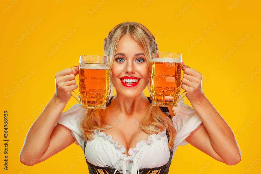 Young sexy Oktoberfest girl waitress, wearing a traditional Bavarian or  german dirndl, serving big beer mugs with drink isolated on yellow  background. Woman pointing to looking up. Stock Photo | Adobe Stock